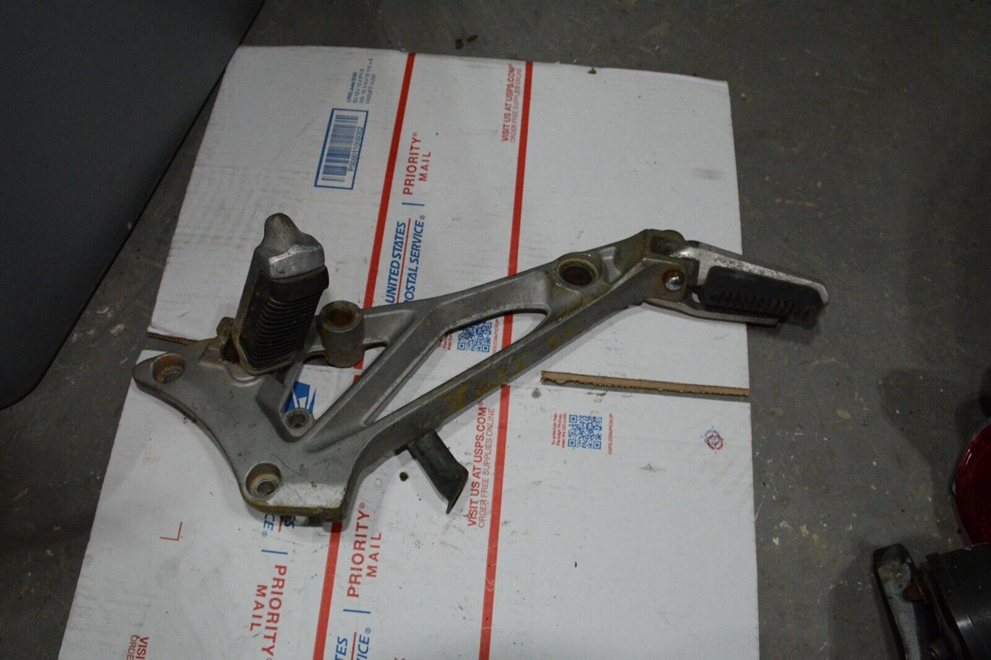 1983 Suzuki GS550E GS 550 E  Right side rear foot peg and mount bracket