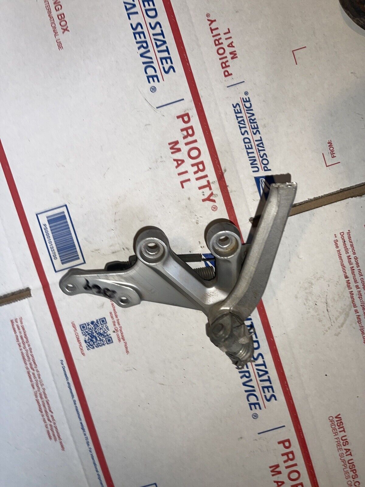 2004 Suzuki GSXR750 Right front foot peg bracket, brake pedal bracket
