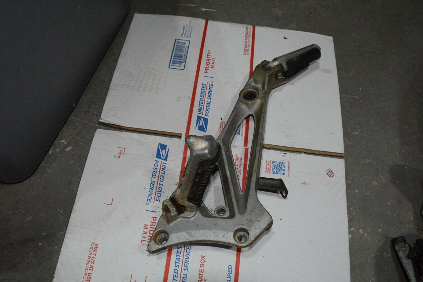 1983 Suzuki GS550E GS 550 E  Right side rear foot peg and mount bracket